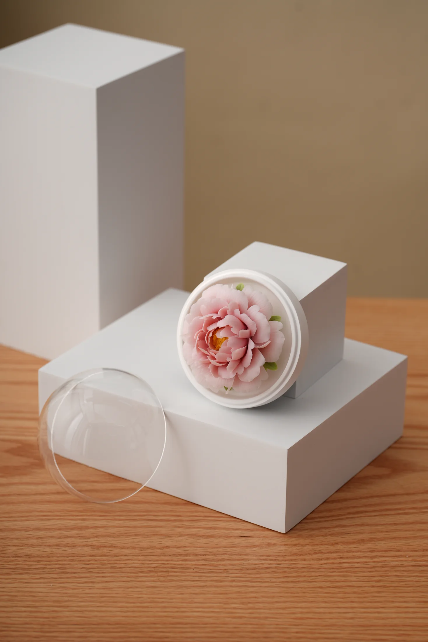 Pink porcelain flower in a clear presentation case