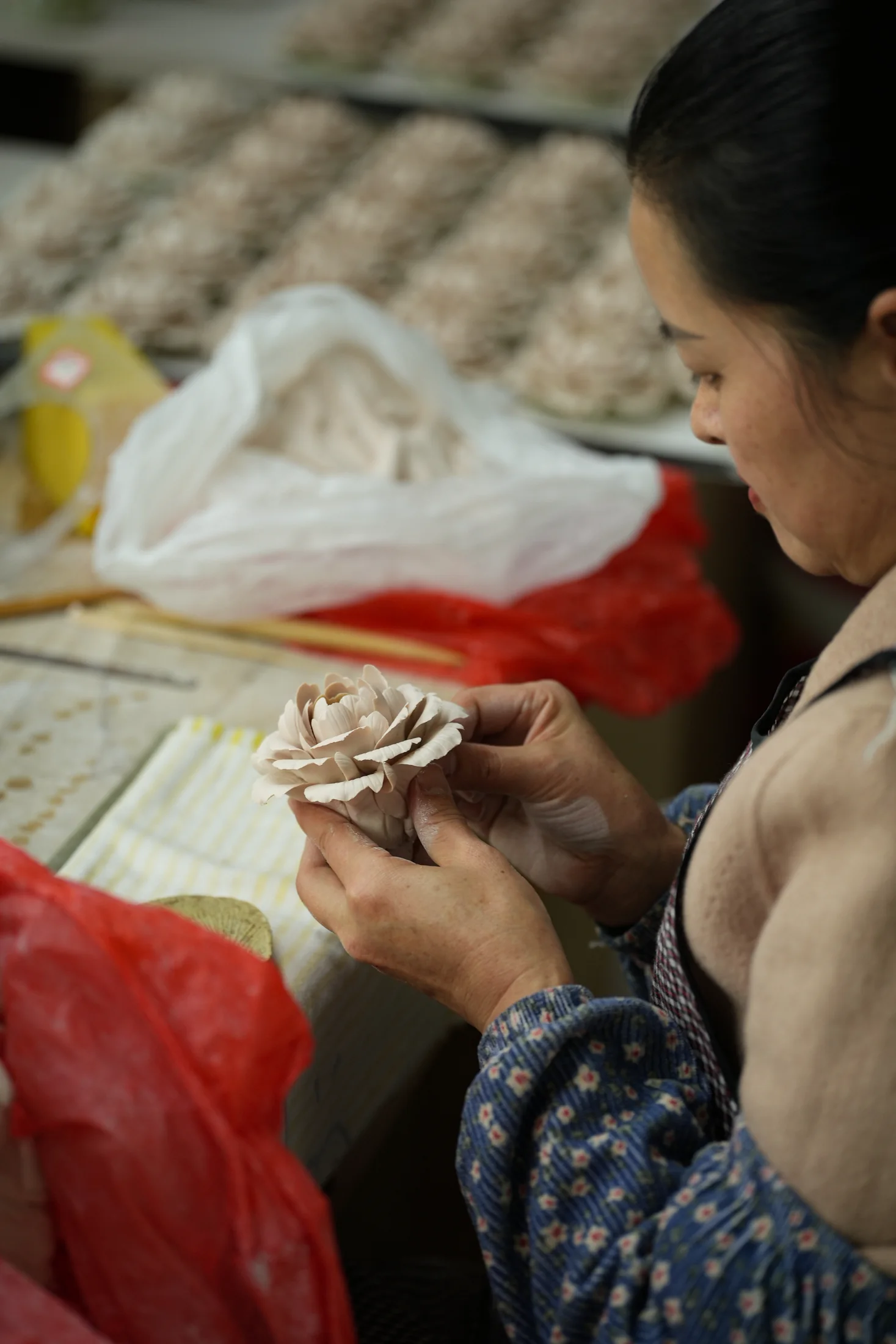 Artisan assembling a hand-sculpted porcelain flower